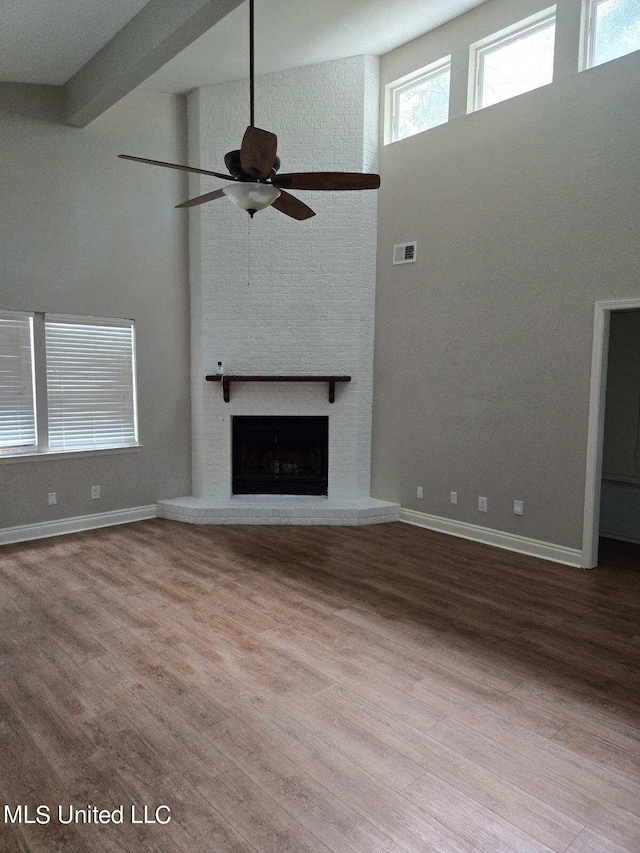 unfurnished living room with ceiling fan, beam ceiling, and light hardwood / wood-style flooring