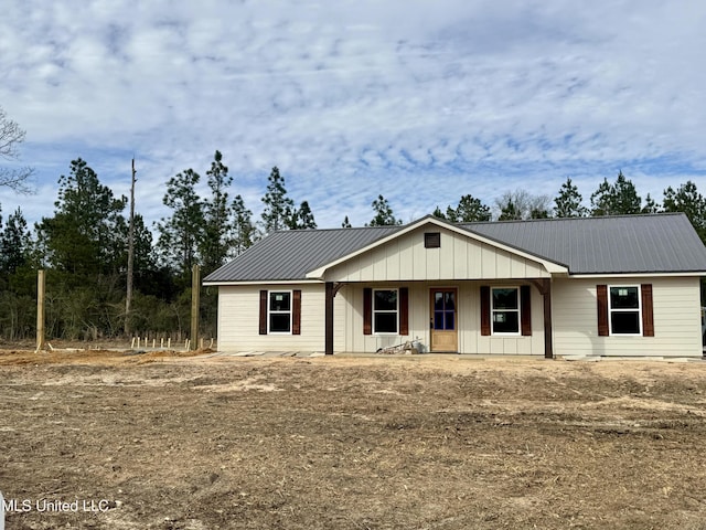 view of front of property featuring board and batten siding and metal roof