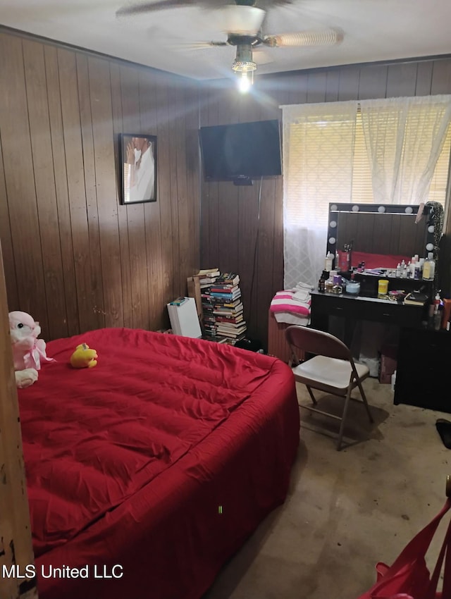 carpeted bedroom featuring wooden walls and ceiling fan