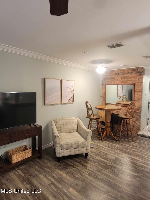interior space featuring crown molding, visible vents, wood finished floors, and baseboards