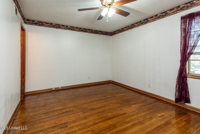 empty room with dark wood-type flooring, a textured ceiling, and ceiling fan