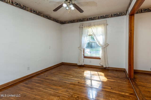 empty room with ceiling fan, a textured ceiling, and dark hardwood / wood-style flooring