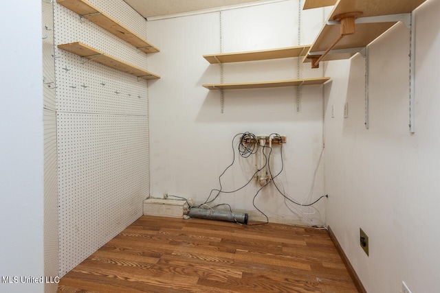 laundry room featuring hookup for an electric dryer and dark hardwood / wood-style floors