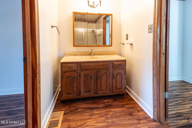 bathroom with vanity and hardwood / wood-style flooring