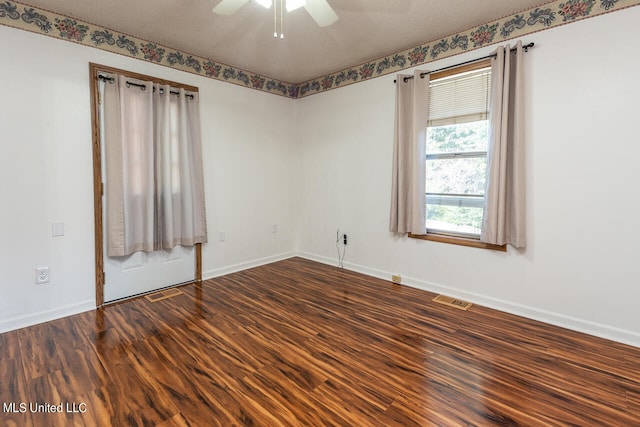 spare room featuring a textured ceiling, ceiling fan, and dark hardwood / wood-style flooring