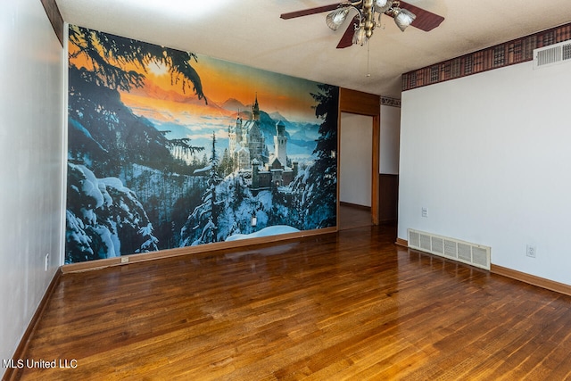 spare room with hardwood / wood-style floors and ceiling fan