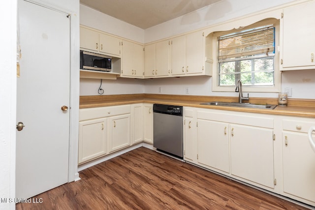 kitchen with dark wood-type flooring, a textured ceiling, appliances with stainless steel finishes, and sink