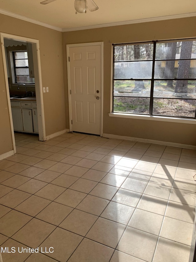 entrance foyer with light tile patterned flooring, baseboards, and ornamental molding