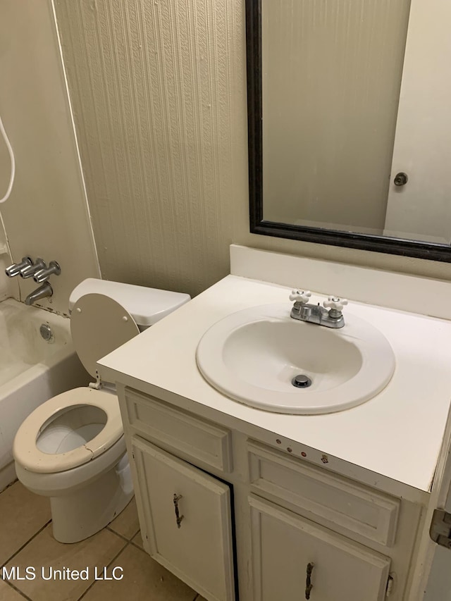 full bath with tile patterned floors, toilet, vanity, and washtub / shower combination