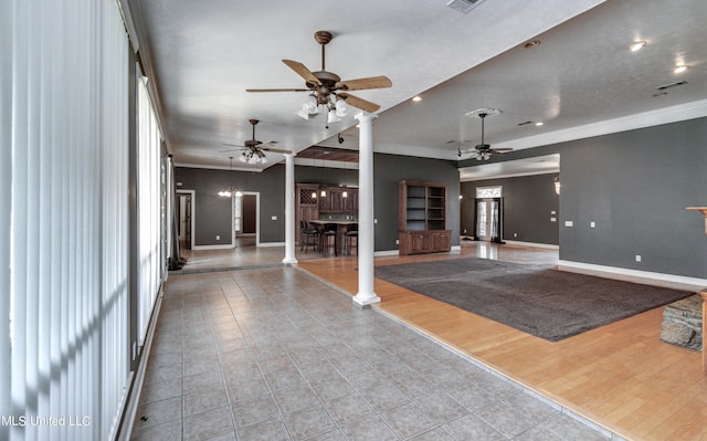 unfurnished living room featuring light hardwood / wood-style floors, ornamental molding, and decorative columns