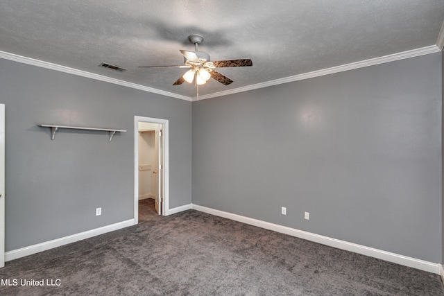 unfurnished bedroom with a textured ceiling, a closet, ceiling fan, dark carpet, and crown molding