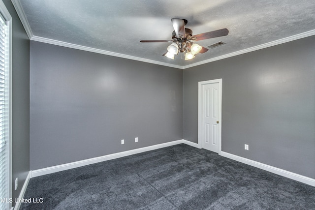 spare room featuring ceiling fan, ornamental molding, a textured ceiling, and dark colored carpet