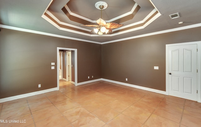 empty room featuring ornamental molding, a tray ceiling, and ceiling fan