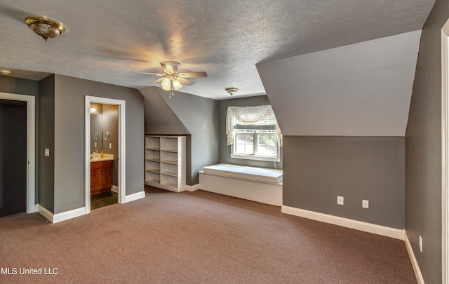 bonus room featuring ceiling fan, lofted ceiling, a textured ceiling, and carpet floors