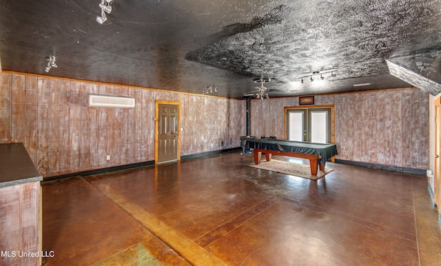 recreation room with pool table, a wall unit AC, track lighting, french doors, and wooden walls