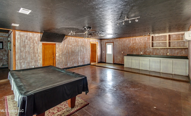 playroom with a textured ceiling, wooden walls, billiards, and ceiling fan