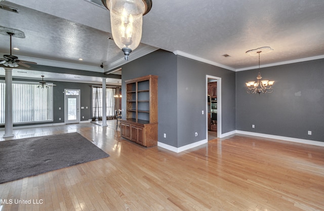 interior space featuring a textured ceiling, light wood-type flooring, decorative columns, ornamental molding, and ceiling fan with notable chandelier