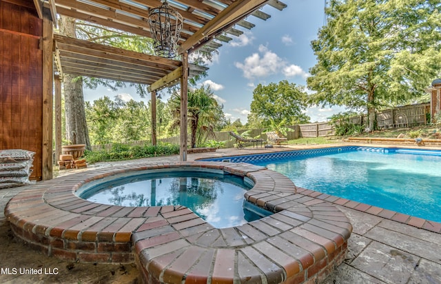 view of swimming pool with an in ground hot tub