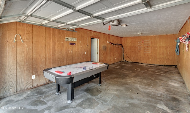 recreation room featuring wood walls