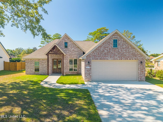 view of front of home with a front lawn and a garage