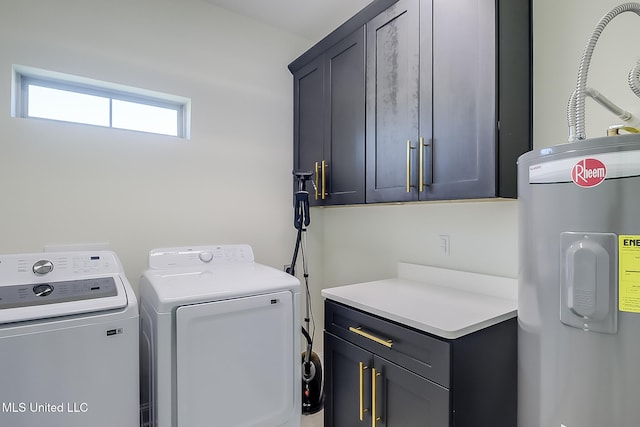 laundry area with cabinets, independent washer and dryer, and water heater