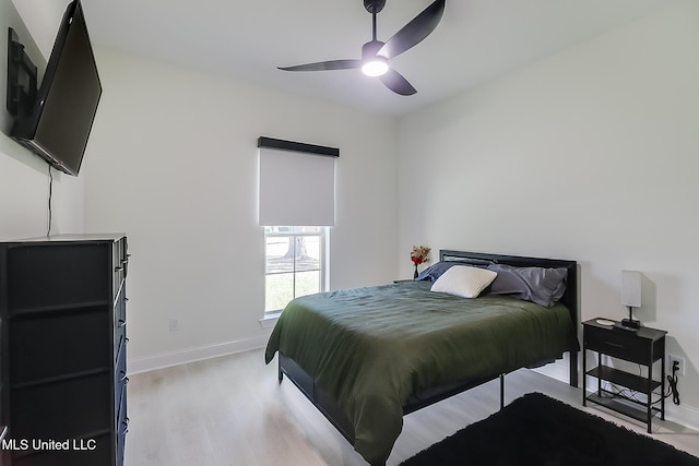 bedroom with light hardwood / wood-style floors and ceiling fan