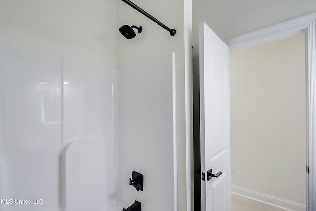 bathroom featuring bathtub / shower combination and hardwood / wood-style flooring