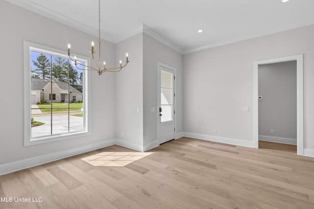 unfurnished dining area featuring a chandelier, baseboards, light wood finished floors, crown molding, and recessed lighting
