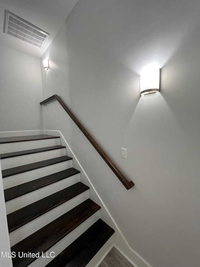 staircase featuring visible vents and baseboards