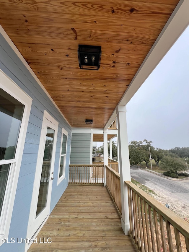 wooden terrace with a porch