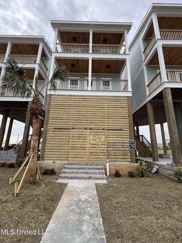 view of front facade featuring stairway and a balcony