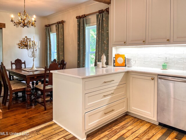 kitchen featuring dishwasher, light hardwood / wood-style flooring, ornamental molding, a notable chandelier, and decorative light fixtures