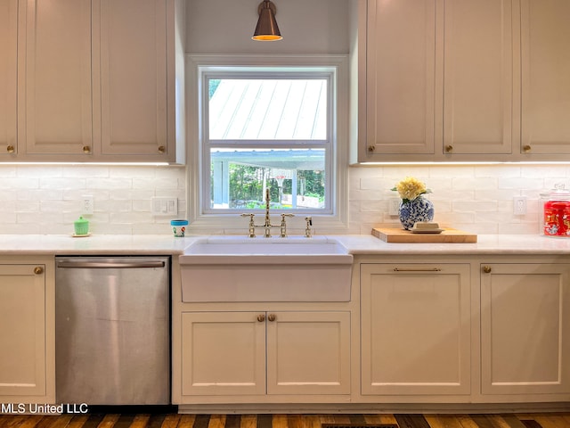 kitchen with stainless steel dishwasher, sink, white cabinetry, and dark hardwood / wood-style floors