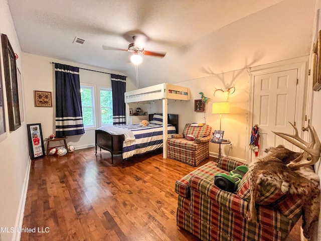 bedroom featuring ceiling fan, a textured ceiling, wood-type flooring, and lofted ceiling