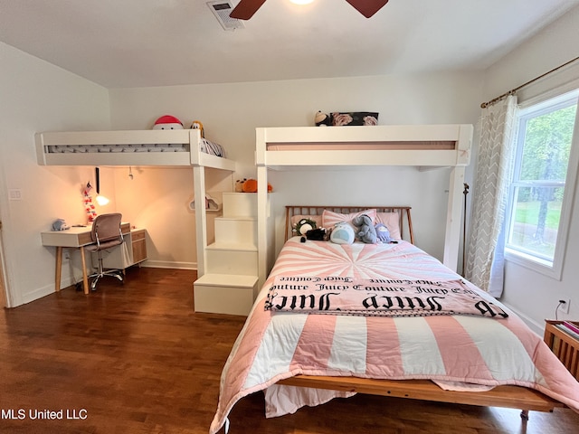 bedroom with dark hardwood / wood-style flooring and ceiling fan