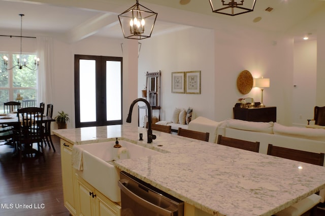 691 Apona St, Diamondhead, MS 39525 - kitchen featuring a chandelier, dishwasher, an island with sink, light stone counters, and beamed ceiling