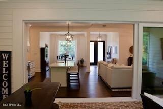 691 Apona St, Diamondhead, MS 39525 - living room with a chandelier and dark wood-style floors