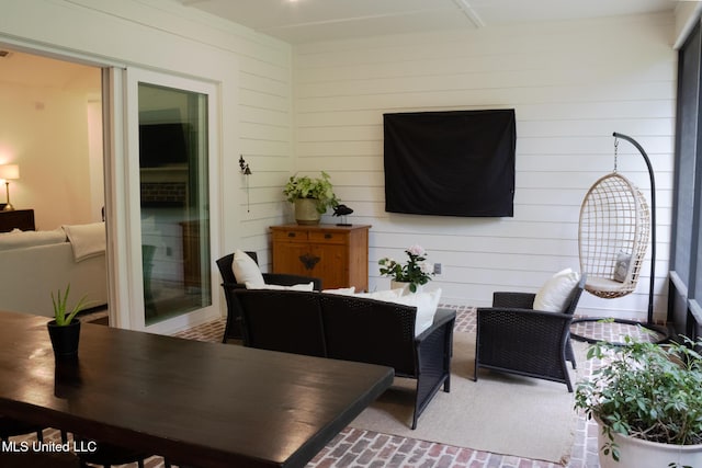 691 Apona St, Diamondhead, MS 39525 - living room featuring brick patterned flooring and wooden walls