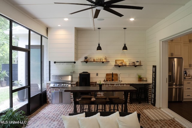 691 Apona St, Diamondhead, MS 39525 - kitchen with stainless steel fridge with ice dispenser, brick flooring, a ceiling fan, a sink, and pendant lighting