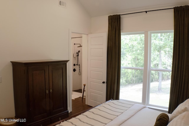 691 Apona St, Diamondhead, MS 39525 - bedroom with lofted ceiling, multiple windows, and dark wood-style floors