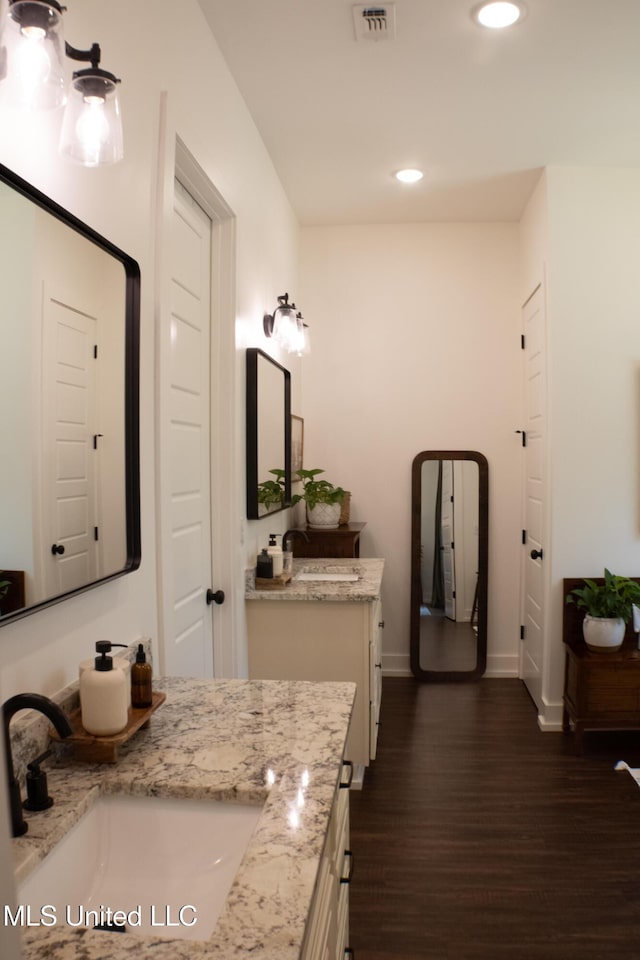 691 Apona St, Diamondhead, MS 39525 - full bathroom with wood finished floors, vanity, recessed lighting, and baseboards