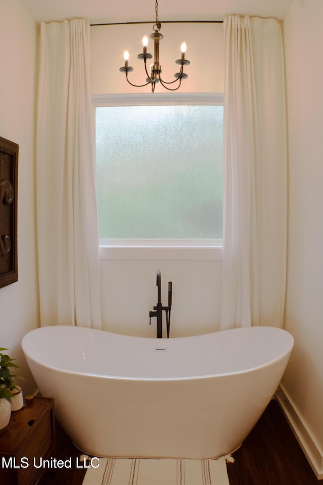 691 Apona St, Diamondhead, MS 39525 - bathroom with a freestanding tub and a chandelier
