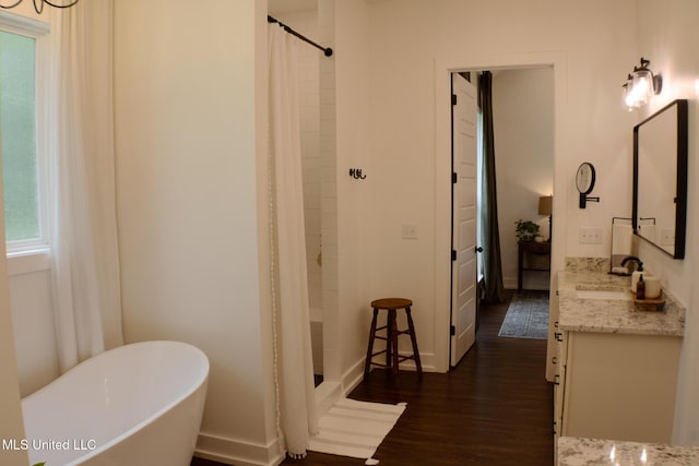 691 Apona St, Diamondhead, MS 39525 - full bathroom featuring vanity, wood finished floors, a stall shower, and a soaking tub