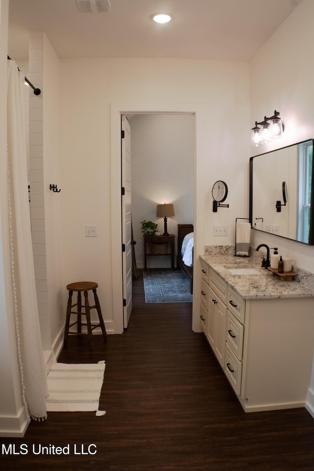 691 Apona St, Diamondhead, MS 39525 - full bath with wood finished floors, vanity, ensuite bath, a shower with shower curtain, and recessed lighting