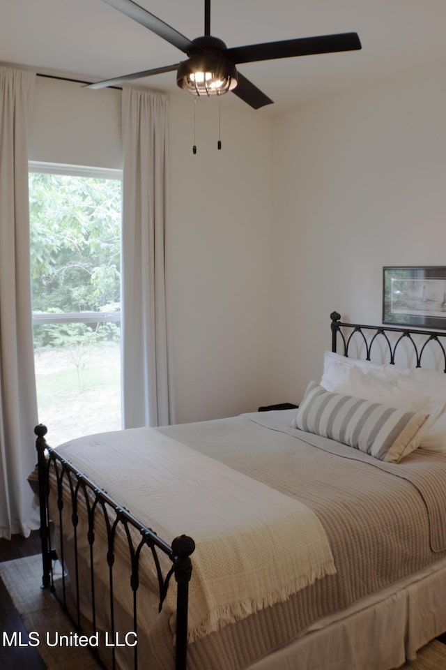 691 Apona St, Diamondhead, MS 39525 - bedroom with wood finished floors and a ceiling fan