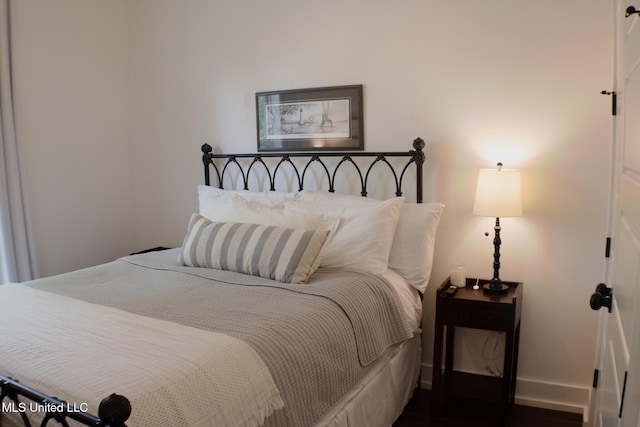 691 Apona St, Diamondhead, MS 39525 - bedroom with baseboards and dark wood finished floors