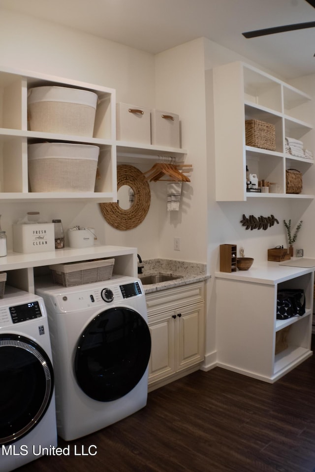 691 Apona St, Diamondhead, MS 39525 - washroom with cabinet space, dark wood-style floors, and independent washer and dryer