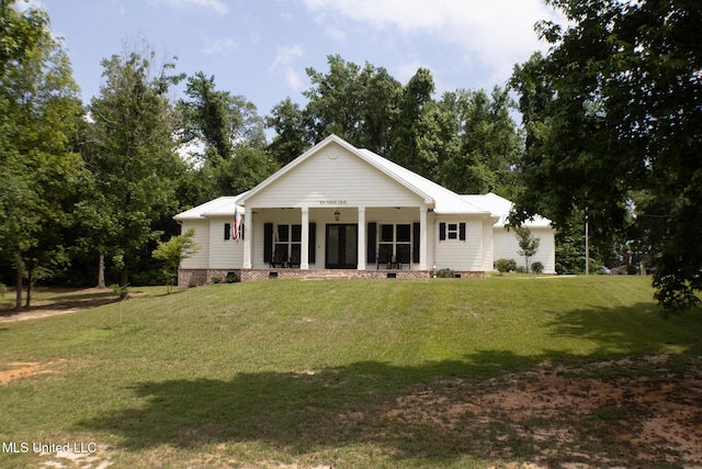 691 Apona St, Diamondhead, MS 39525 - view of front facade with crawl space, a front lawn, and covered porch
