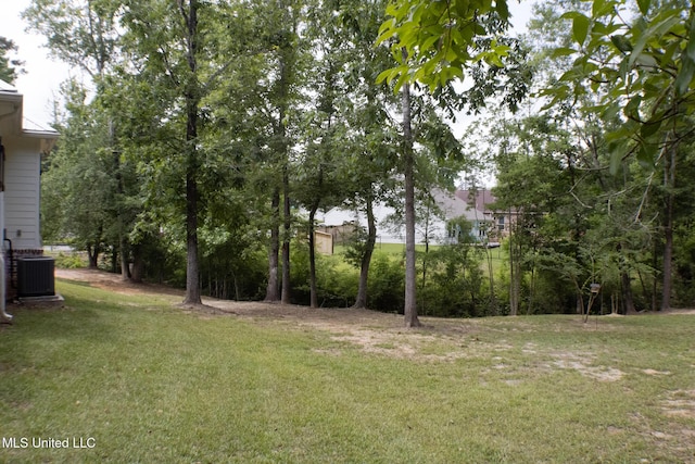 691 Apona St, Diamondhead, MS 39525 - view of green lawn featuring central AC unit