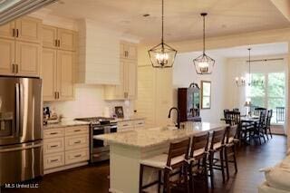 691 Apona St, Diamondhead, MS 39525 - kitchen featuring stainless steel appliances, a chandelier, a breakfast bar, and an island with sink